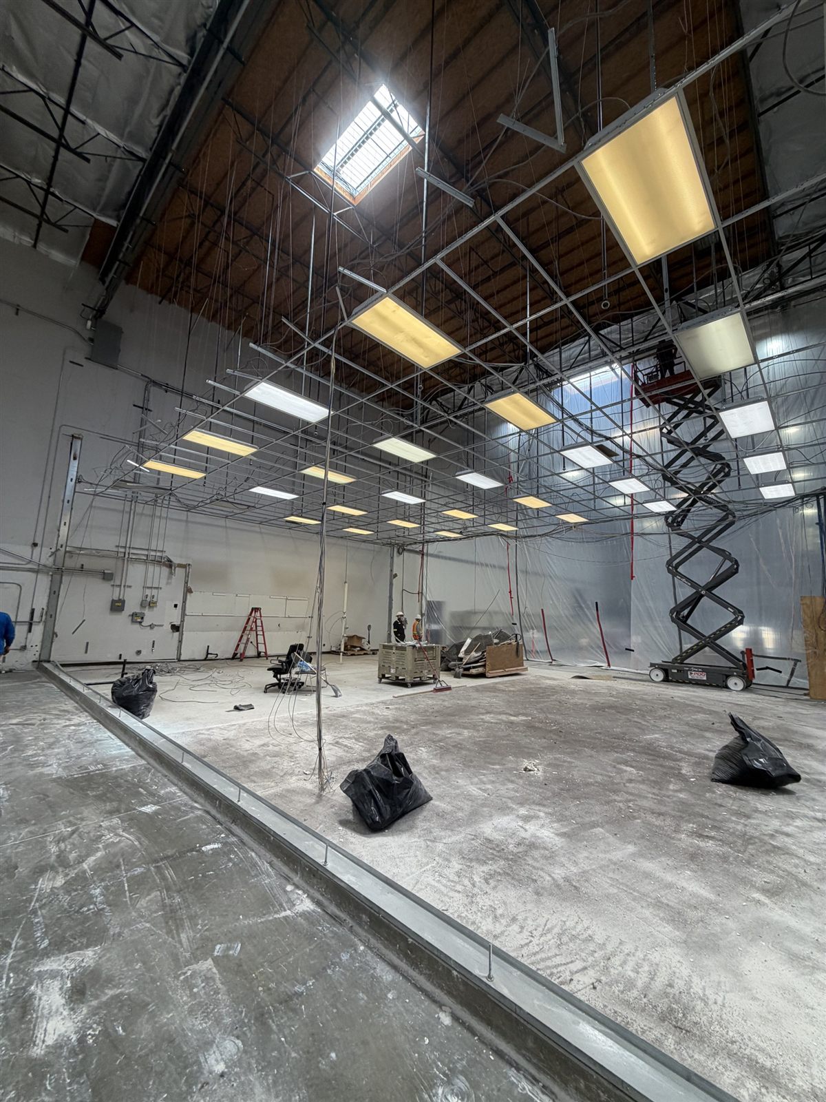 Wide-open warehouse interior swept clean after commercial interior demolition
